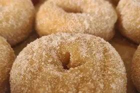 A row of hot cinnamon sugar doughnuts